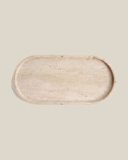 ATOMS OVAL Tray beige travertine, top view on a BONE background