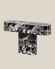 BUTTER console table by CARVINGS in Grand Antique Black Marble, on a BONE background, right view.