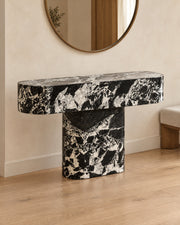 BUTTER console table by CARVINGS in Grand Antique Black Marble, in a styled interior, right view.