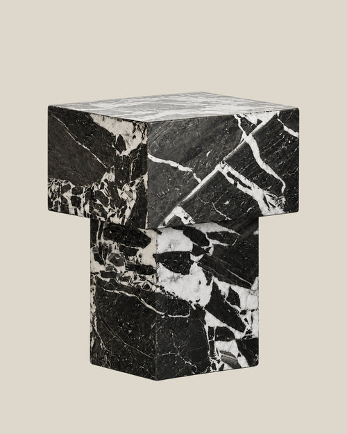 BUTTER side table by CARVINGS in Grand Antique Black Marble, on a BONE background, right view.