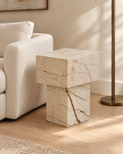 BUTTER side table by CARVINGS in Sofita Beige Marble, in a styled living room, right view.