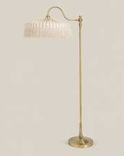 FRINGE Floor Lamp — Ivory shade and brass stand on Bone background