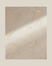 Close-up of PAD Tray's beige natural stone, subtle surface markings and softly curved recess.