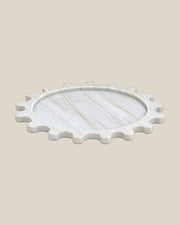 Sun Orbit Tray in Calacatta Gold natural marble, low front view, rounded sun rays and recessed circular centre.